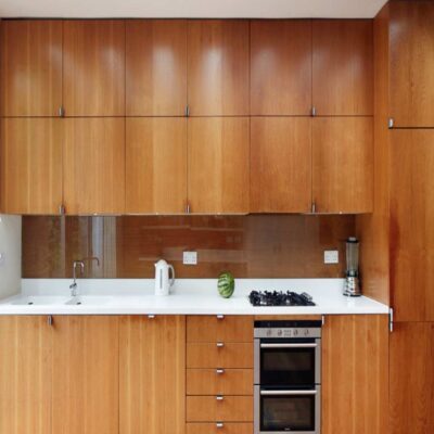 modular kitchen with veneer shutters and inbuilt microwave and oven installed in gurgaon