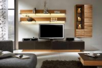 a minimalistic tv unit with extensive inbuilt lights and wall panelling