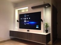 a compact tv units with lot of storage drawers and dark walnut colour combination