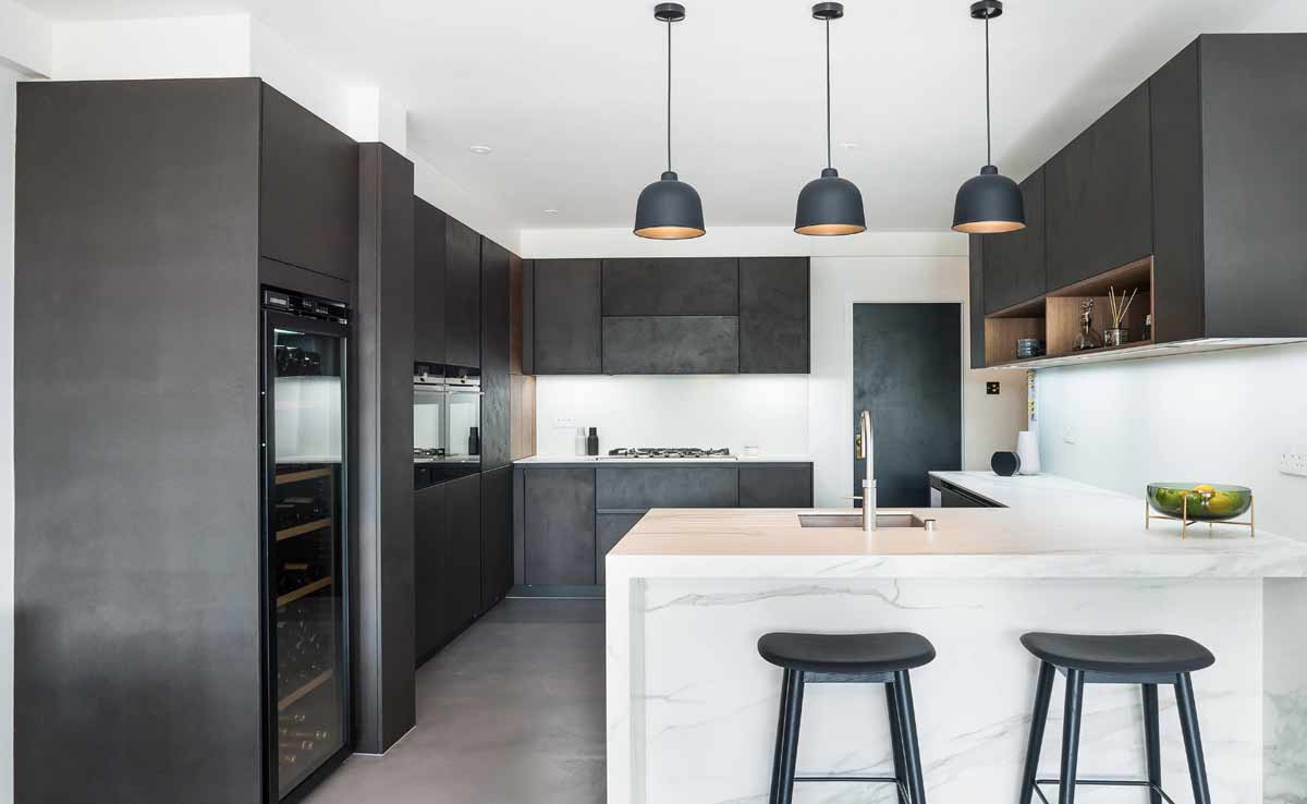 a modular kitchen with quartz countertop and black kitchen shutters manufactured in gurgaon and delhi